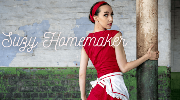 ballet dancy in red dress holding onto a pole