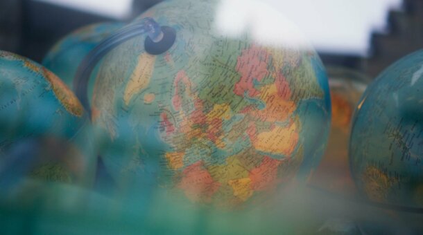 Plastic globes through a shop window